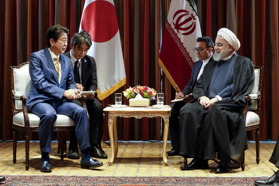 In this photo released by the official website of the office of the Iranian Presidency, President Hassan Rouhani, right, meets Japanese Prime Minister Shinzo Abe, left, on the sideline of the United Nations General Assembly at the United Nations, Tuesday, Sept. 24, 2019. (Iranian Presidency Office via AP)