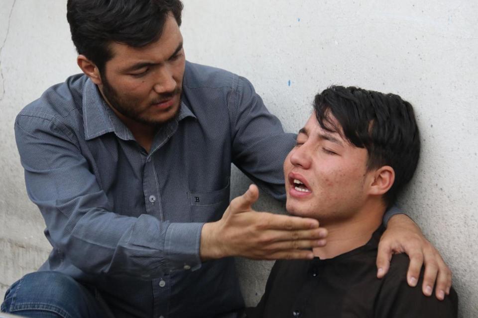 An Afghan resident weeps for his relative following the suicide attack in Kabul (AFP/Getty Images)