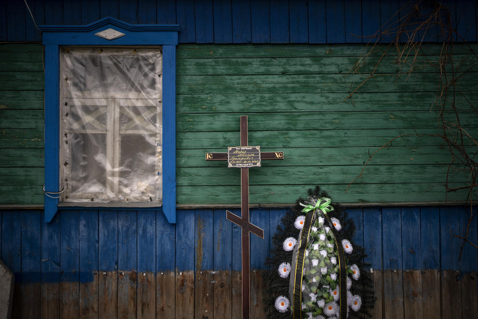 A cross with the name of Mykola Moroz, 47, is photographed at his house, before his funeral at the Ozera village, near Bucha, Ukraine, Tuesday, April 26, 2022. Mykola was captured by the Russian army from his house in the Ozera village on March 13, taken for several weeks to an unknown location and finally found killed with gunshots at about 15 kilometres away from his house. (AP Photo/Emilio Morenatti)