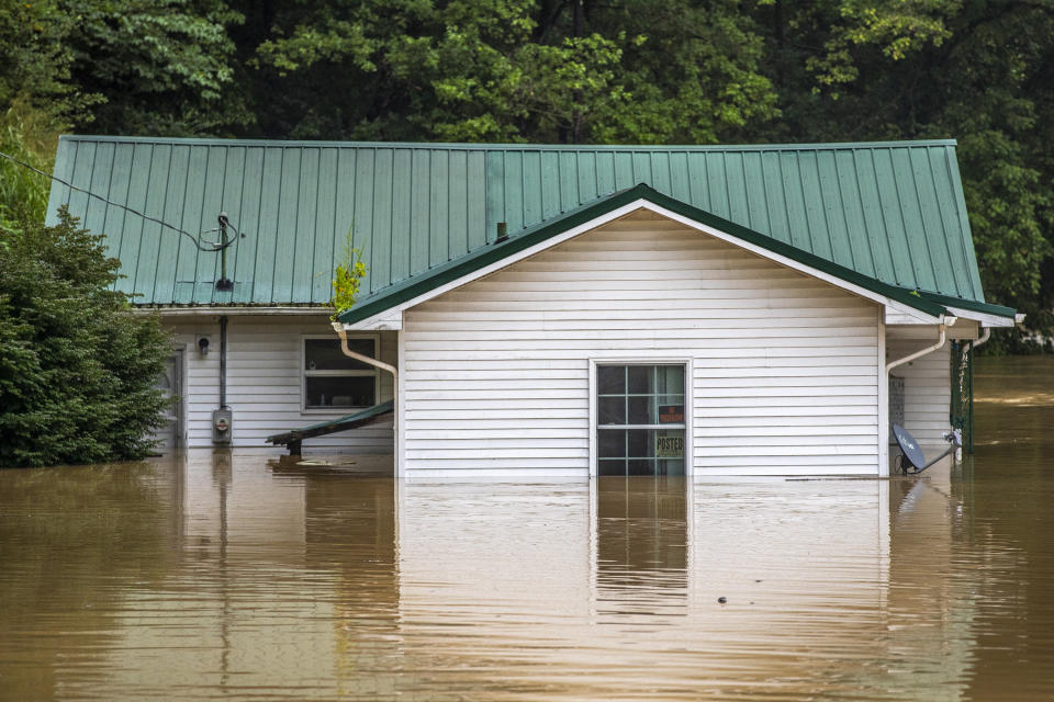 Homes are flooded by Lost Creek, Ky., on Thursday, July 28, 2022. Heavy rains have caused flash flooding and mudslides as storms pound parts of central Appalachia. Kentucky Gov. Andy Beshear says it's some of the worst flooding in state history. (Ryan C. Hermens/Lexington Herald-Leader via AP)