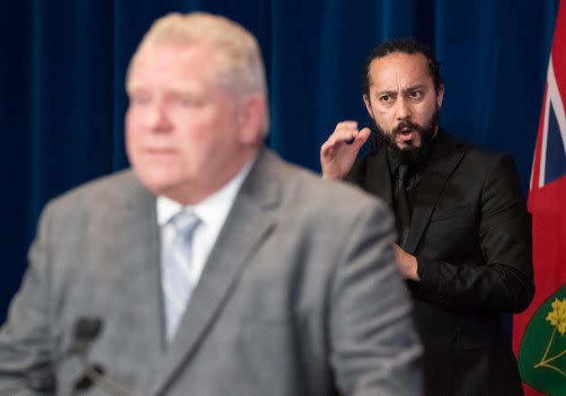 ASL interpreter Christopher Desloges works behind Doug Ford during the daily briefing at Queen's Park.