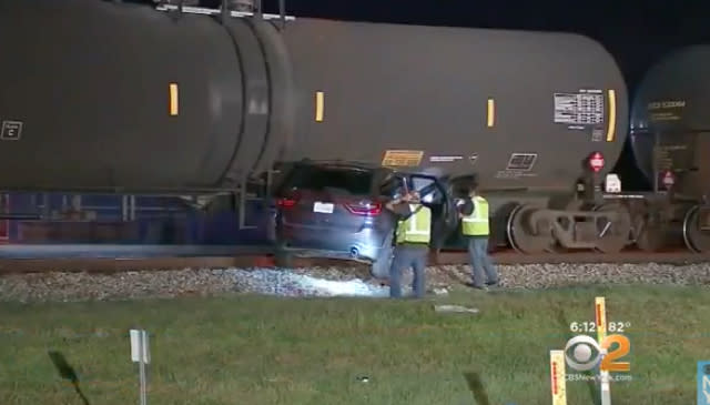 Train drags stuck SUV along railway track with people trapped inside