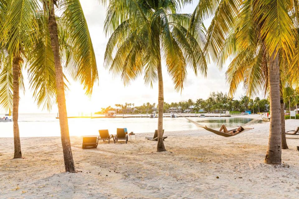 Woman in a hammock on the beach in the Cayman Islands