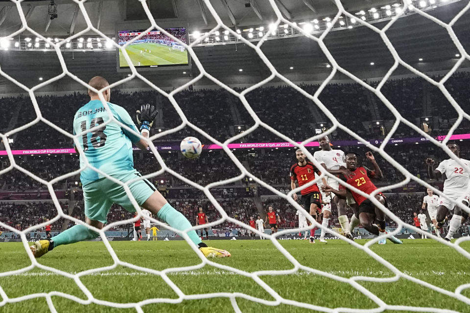 Belgium's Michy Batshuayi, number 23, scores his side's opening goal during the World Cup group F soccer match between Belgium and Canada, at the Ahmad Bin Ali Stadium in Doha, Qatar, Wednesday, Nov. 23, 2022. (AP Photo/Hassan Ammar)