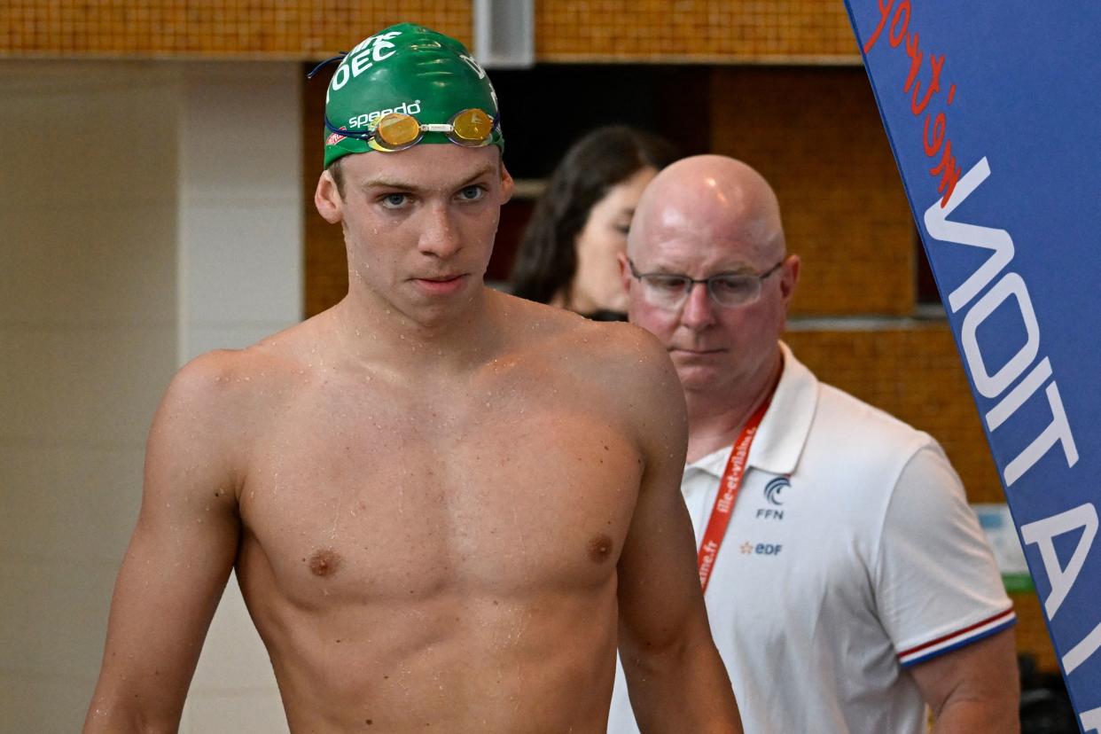 French swimmer Leon Marchand (L) walks with his US coach Bob Bowman during the French swimming championships in Rennes, western France, on June 15, 2023. (Photo by Damien MEYER / AFP) (Photo by DAMIEN MEYER/AFP via Getty Images)