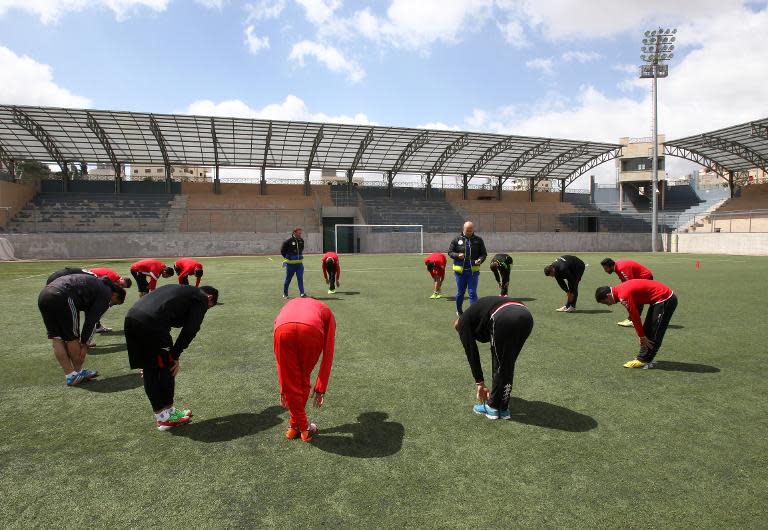 Ahli Al-Khalil football club's coach, Italian Stefano Cusin (C-L) leads a training session on April 24, 2015 in the West Bank town of Hebron