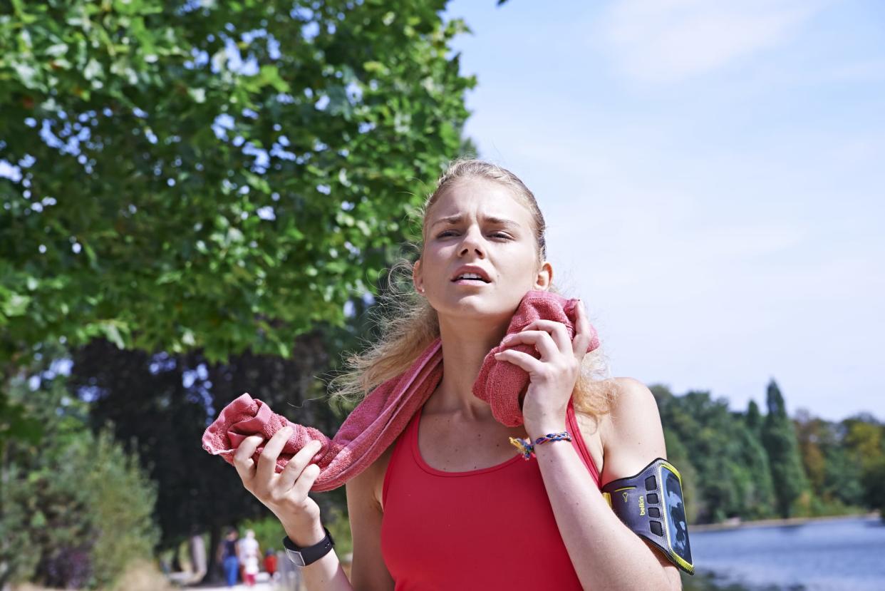 Woman wiping her face after exercising