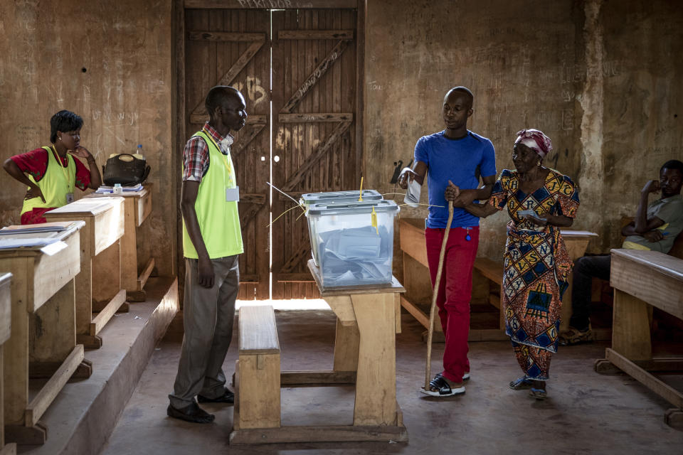 People cast their votes for presidential and legislative elections, at the Lycee Boganda polling station in the capital Bangui, Central African Republic Sunday, Dec. 27, 2020. President Faustin-Archange Touadera and his party said the vote will go ahead after government forces clashed with rebels in recent days and some opposition candidates pulled out of the race amid growing insecurity. (AP Photo)