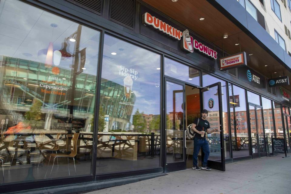 FILE - In this June 12, 2019, file photo a customer leaves a Dunkin' Donuts store in Harrison, N.J. Dunkin' Brands Group Inc. reports financial earns on Thursday, Oct. 31. (AP Photo/Mary Altaffer, File)