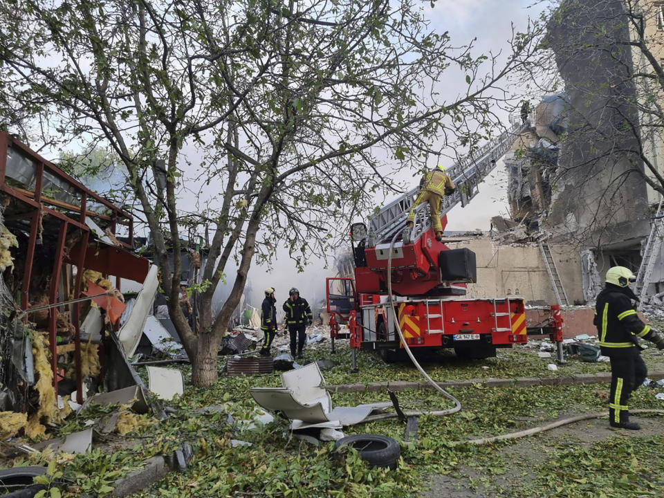 In this photo provided by the Ukrainian Emergency Service, emergency services personnel work to extinguish a fire following a Russian attack in Cherkasy, Ukraine, Thursday, Sept. 21, 2023. (Ukrainian Emergency Service via AP)