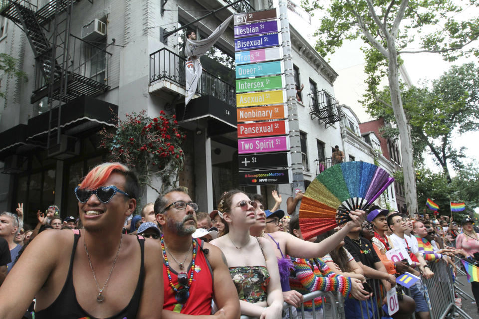 Spectators react as the LBGTQ Pride march makes its way along Christopher Street in New York, Sunday, June 30, 2019. (AP Photo/Tina Fineberg)