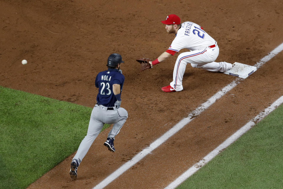 Texas Rangers first baseman Todd Frazier (21) reaches out for the throw to the bag against Seattle Mariners’ Austin Nola’s infield groundout in the second inning of a baseball game in Arlington, Texas, Monday, Aug. 10, 2020. (AP Photo/Tony Gutierrez)