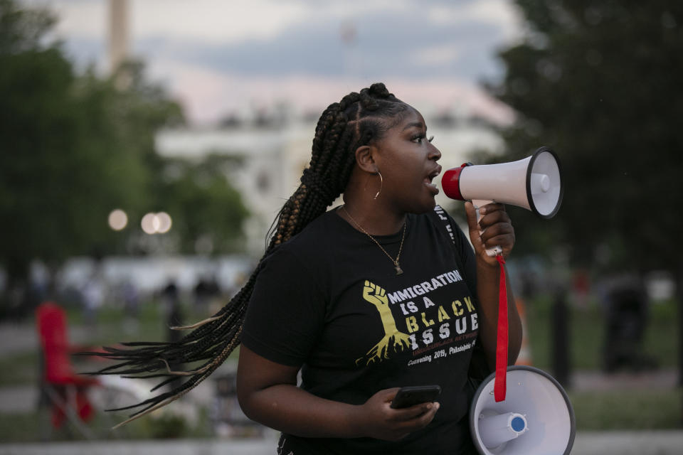 In this June 12, 2020 photo, Joella Roberts, 22, of Washington, who is a recipient of the Deferred Action for Childhood Arrivals (DACA) program and is originally from Trinidad and Tobago, leads a protest near the White House in Washington, over the death of George Floyd, a black man who was in police custody in Minneapolis. On Thursday, June 18, The U.S. Supreme Court has kept alive the Obama-era program that allows immigrants brought here as children to work and protects them from deportation. (AP Photo/Jacquelyn Martin)
