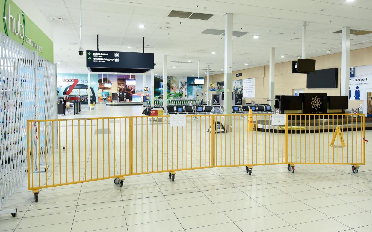 The empty arrivals terminal at the Gold Coast Airport is closed off by barriers in a photo dated 10 July 2020 - ALBERT PEREZ/EPA-EFE/Shutterstock