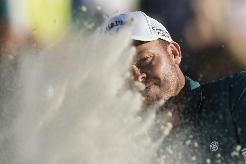 Danny Willett, of England, hits from the bunker on the 18th hole during third round at the Masters golf tournament at Augusta National Golf Club Saturday, April 13, 2024, in Augusta, Ga. (AP Photo/Charlie Riedel)