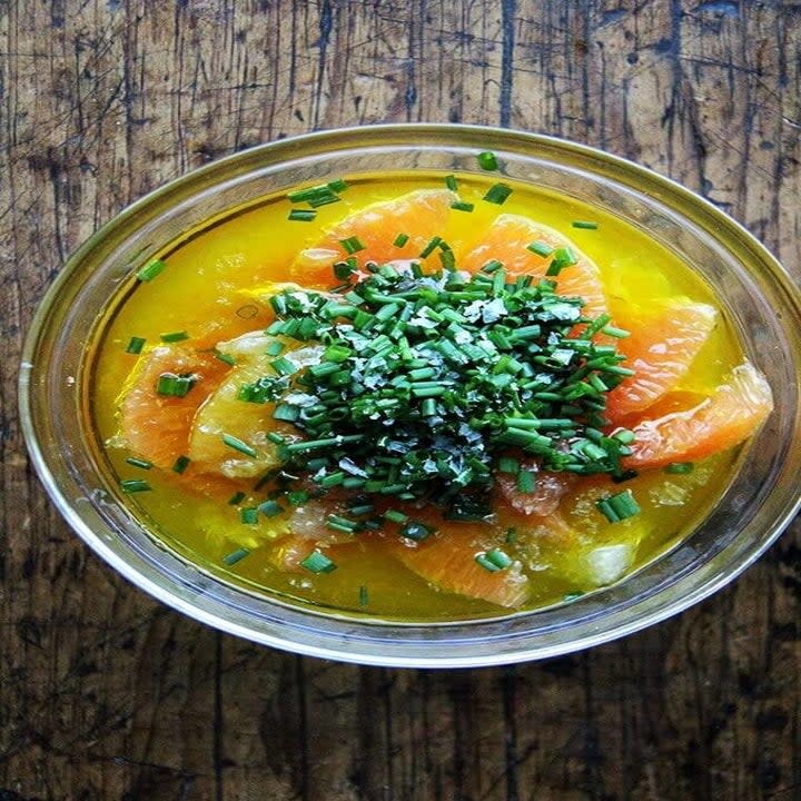 Citrus sauce with chives in a small bowl.