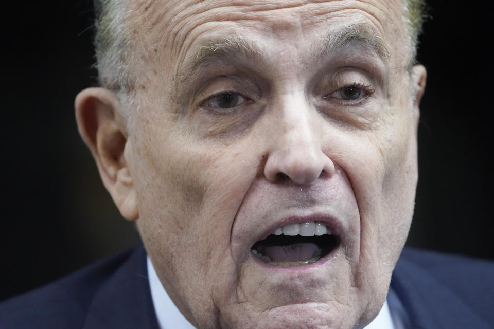 Former Mayor of New York Rudy Giuliani speaks to reporters as he leaves his apartment building in New York, Wednesday, Aug. 23, 2023. (AP Photo/Seth Wenig)