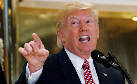 FILE PHOTO: U.S. President Donald Trump answers questions about his response to the violence, injuries and deaths at the "Unite the Right" rally in Charlottesville as he talks to the media in the lobby of Trump Tower in Manhattan, New York, U.S., August 15, 2017. REUTERS/Kevin Lamarque/File Photo