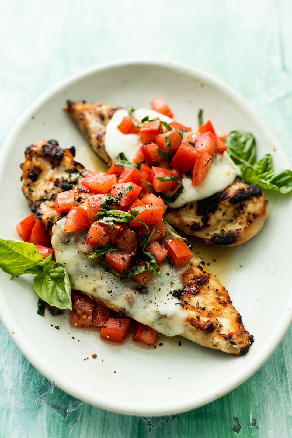 <p>The least basic grilled chicken has ever looked.</p><p>Get the recipe from <a href="https://www.delish.com/cooking/recipe-ideas/a53594/grilled-bruschetta-chicken-recipe/" rel="nofollow noopener" target="_blank" data-ylk="slk:Delish" class="link ">Delish</a>.</p>