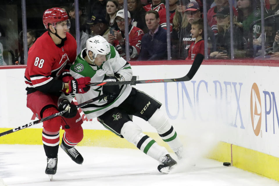 Carolina Hurricanes' Martin Necas (88) battles Dallas Stars' John Klingberg (3) for the puck during the second period of an NHL hockey game in Raleigh, N.C., on Tuesday, Feb. 25, 2020. (AP Photo/Chris Seward)