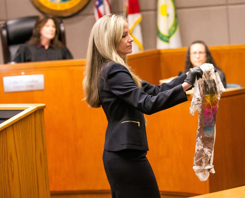 Assistant State Attorney Marissa Meyer shows jurors evidence during trial.