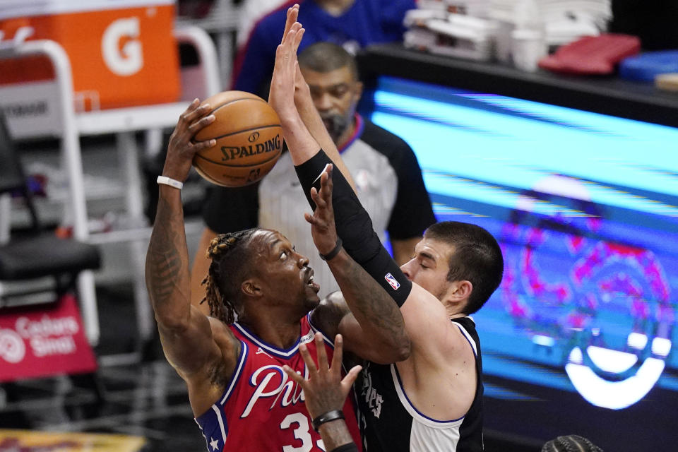 Philadelphia 76ers center Dwight Howard, left, shoots as Los Angeles Clippers center Ivica Zubac defends during the first half of an NBA basketball game Saturday, March 27, 2021, in Los Angeles. (AP Photo/Mark J. Terrill)