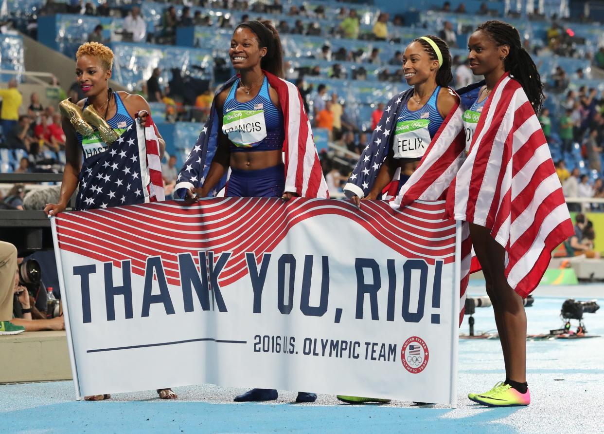 The United States' Courtney Okolo, Natasha Hastings, Phyllis Francis and Allyson Felix after winning the gold in the women's 4x400 meter relay at the 2016 Summer Olympics inside Olympic stadium in Rio de Janeiro, Brazil.