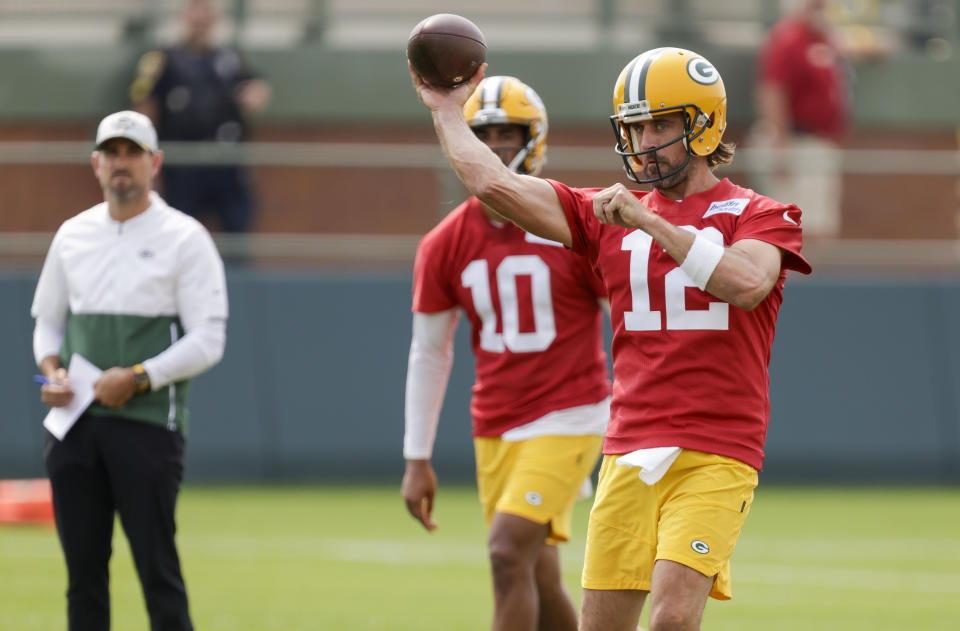 Green Bay Packers' quarterback Aaron Rodgers (12) passes while head coach Matt LaFleur and quarterback Jordan Love (10) watch during NFL football training camp Wednesday, July 28, 2021, in Green Bay, Wis. (AP Photo/Matt Ludtke)