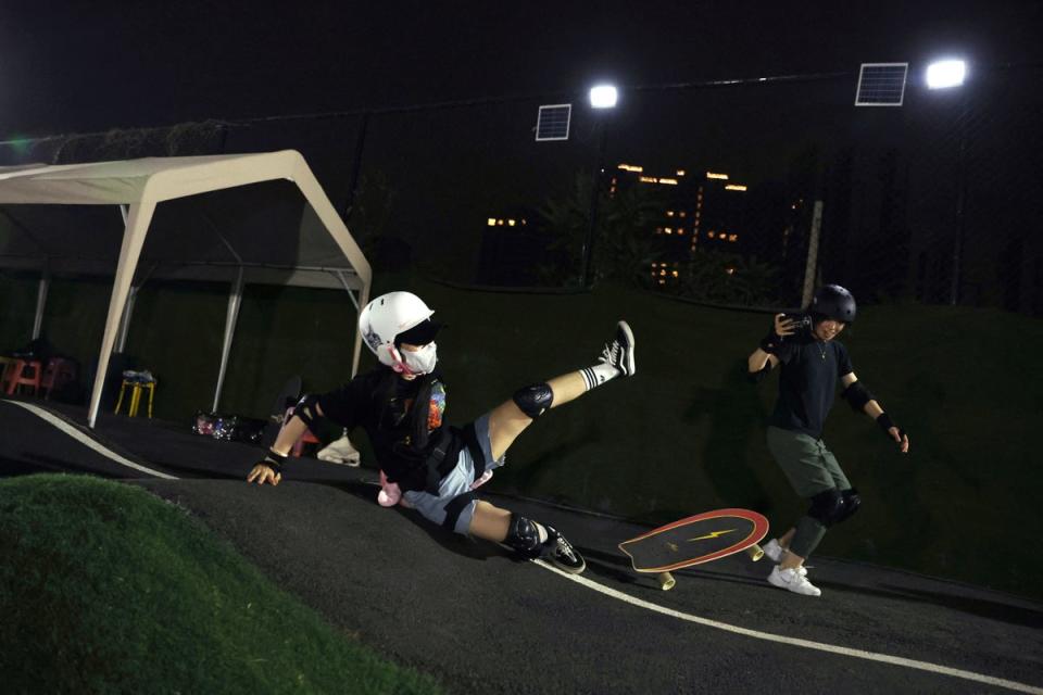 A boarder falls at a pump track in Beijing (Reuters)