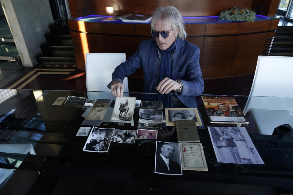 Jed Leiber shows photos of his grandfather Saemy Rosenberg's life at home Thursday, Dec. 3, 2020, in Los Angeles. (AP Photo/Marcio Jose Sanchez)