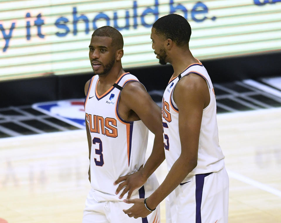 Chris Paul #3 of the Phoenix Suns and Mikal Bridges #25 talk during the fourth quarter in a 113-103 LA Clippers win at Staples Center on April 08, 2021 in Los Angeles, California. (Photo by Harry How/Getty Images) NOTE TO USER: User expressly acknowledges and agrees that, by downloading and or using this photograph, User is consenting to the terms and conditions of the Getty Images License Agreement.