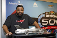 Daytona 500 honorary starter DJ Khaled poses next to the Harley J. Earl trophy during a news conference after the NASCAR Daytona 500 auto race was postponed Sunday, Feb. 18, 2024, at Daytona International Speedway in Daytona Beach, Fla. (AP Photo/Terry Renna)