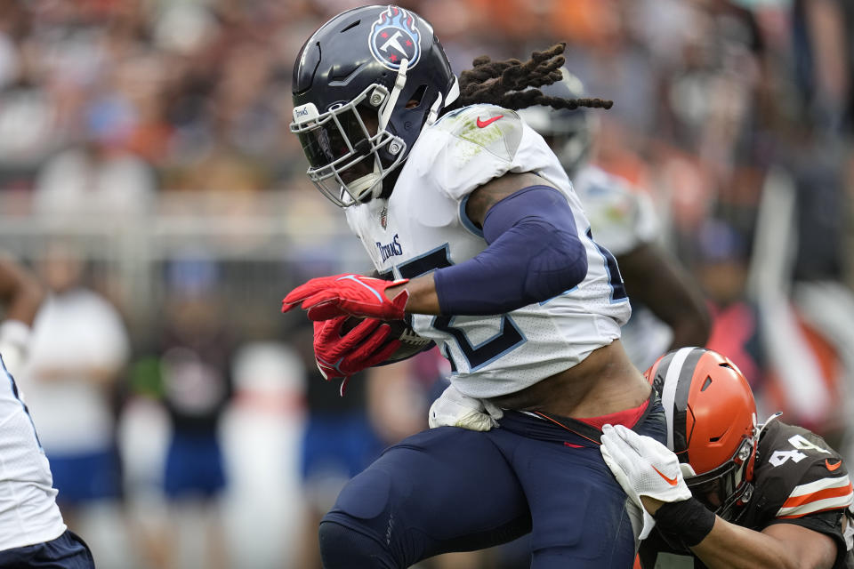 Tennessee Titans running back Derrick Henry, left, is tackled by Cleveland Browns linebacker Sione Takitaki, right, during the second half of an NFL football game Sunday, Sept. 24, 2023, in Cleveland. (AP Photo/Sue Ogrocki)