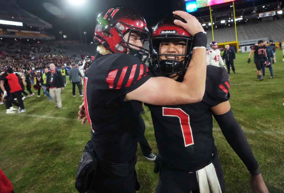 Liberty quarterbacks Navi Bruzon (7) and Hayden Fletcher (11) celebrate their 33-21 win over Centennial for the Open Division State Championship at Mountain America Stadium in Tempe on Dec. 2, 2023.