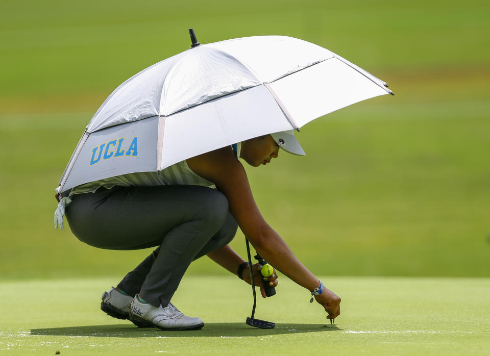 FILE - In this Thursday, May 31, 2018, file photo, Patty Tavatanakit, of Thailand, fixes a divot on the 18th green during the first round of the U.S. Women's Open golf tournament, in Shoal Creek, Ala. Tavatanakit has secured her LPGA Tour card. (AP Photo/Butch Dill, File)