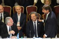 Argentina's President Alberto Fernandez, left, with his Minister of Foreign Affairs Santiago Cafiero, center, and Uruguay's President Luis Lacalle Pou, right, talk before the start of the Mercosur trade bloc summit in Montevideo, Uruguay, Tuesday, Dec. 6, 2022. (AP Photo/Matilde Campodonico)