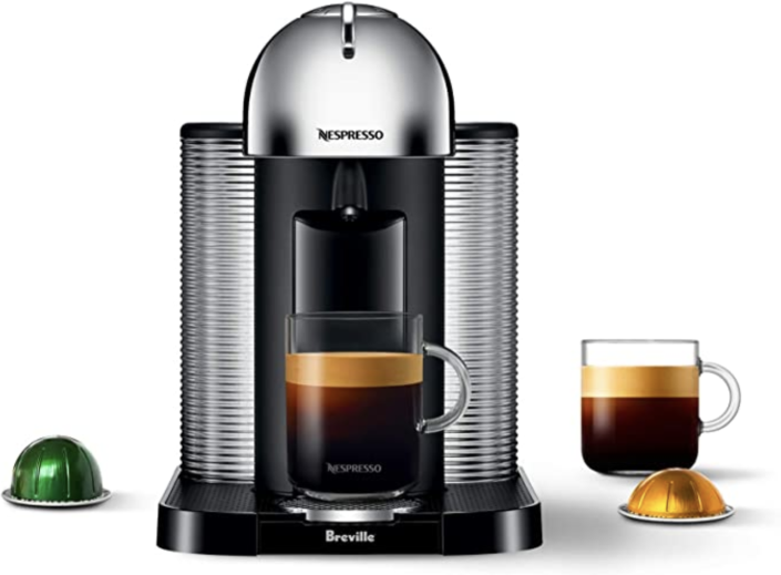 Nespresso Vertuo Coffee and Espresso Machine with two cups of coffee and nespresso pods (Photo via Amazon)