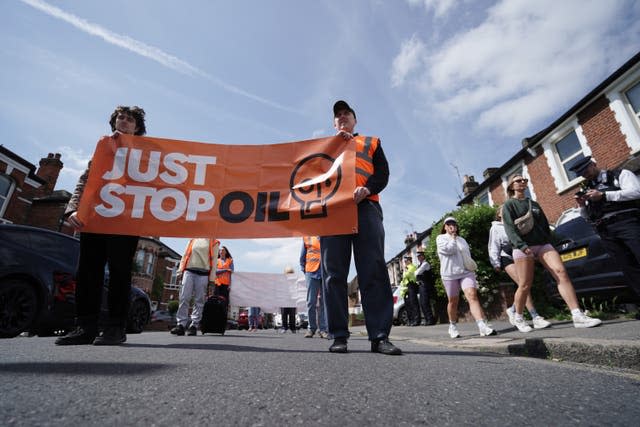 Activists take part in a slow walk protest near Wimbledon Magistrates’ Court 