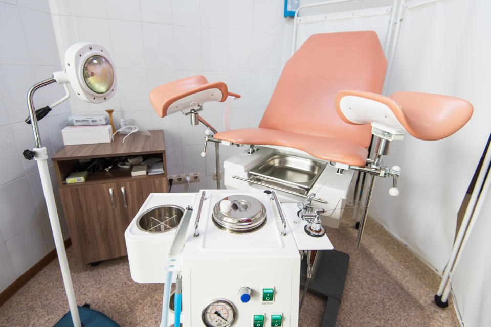 Gynecological cabinet with chair and other medical equipment in modern clinic