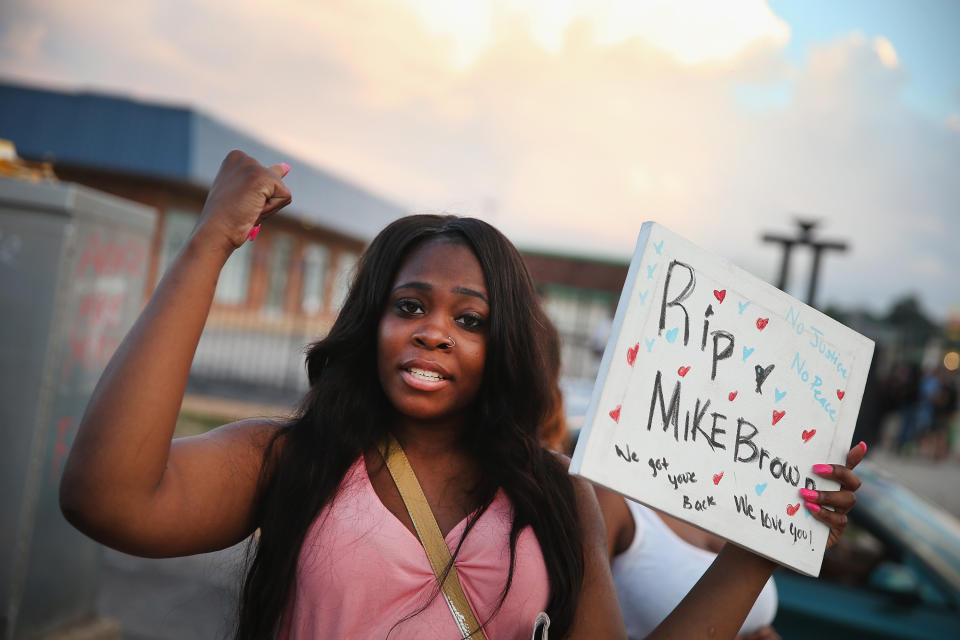 FERGUSON, MO - AUGUST 11: Arniesha Randall protests the killing of 18-year-old Michael Brown who  was shot by police on Saturday on August 11, 2014 in Ferguson, Missouri. Police responded with tear gas and rubber bullets as residents and their supporters protested the shooting by police of an unarmed black teenager named Michael Brown who was killed Saturday in this suburban St. Louis community. Yesterday 32 arrests were made after protests turned into rioting and looting in Ferguson.  (Photo by Scott Olson/Getty Images)