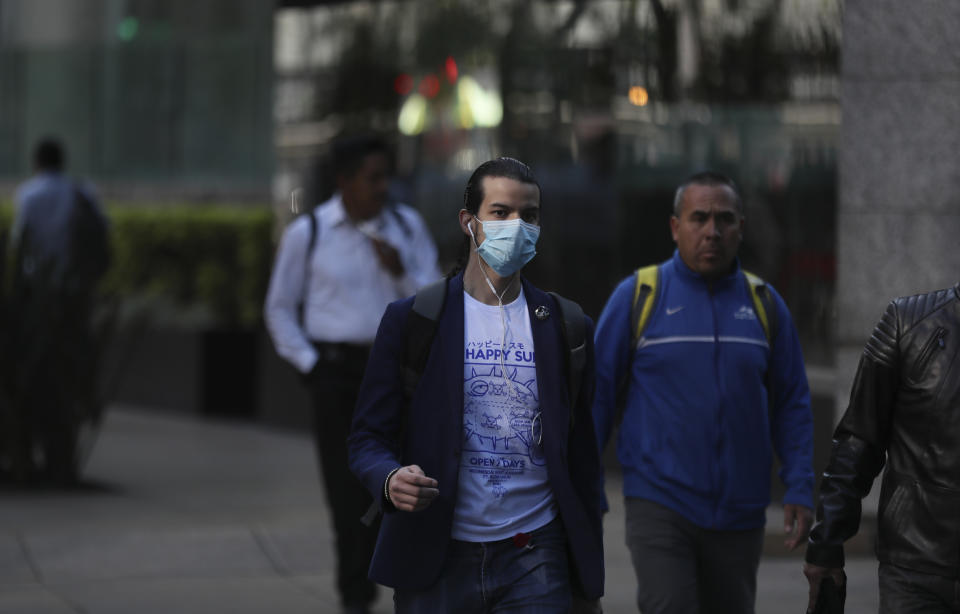 A man wears a mask over his mouth as a precaution against the spread of the new coronavirus COVID-19 in Mexico City, Friday, Feb. 28, 2020. Mexico’s assistant health secretary announced Friday that the country now has confirmed cases of the new coronavirus. (AP Photo/Fernando Llano)