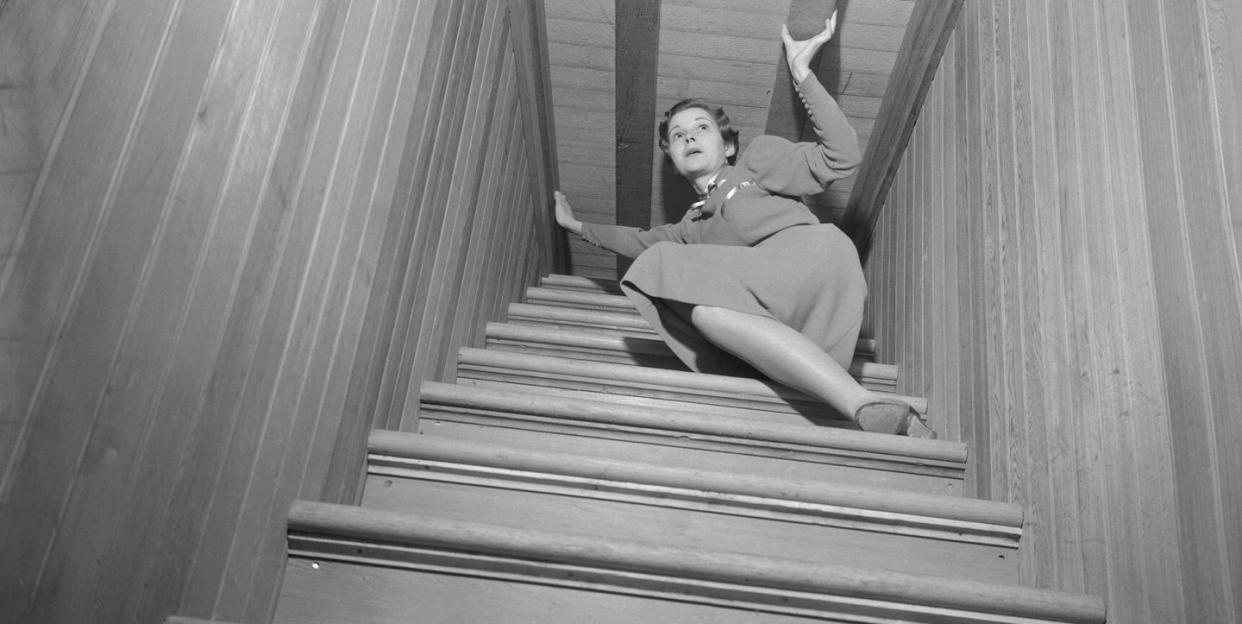 woman on narrow staircase at winchester mystery house