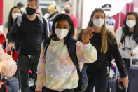 Simone Biles, center, and the U.S. Women's Gymnastics team arrive for the Tokyo 2020 Summer Olympic Games at Narita International Airport Thursday, July 15, 2021, in Narita, east of Tokyo. (AP Photo/Kiichiro Sato)