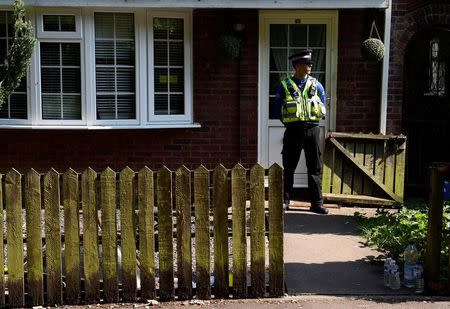 A police officer stands outside the home of Darren Osborne, in Cardiff, Wales June 20, 2017. REUTERS/Rebecca Naden