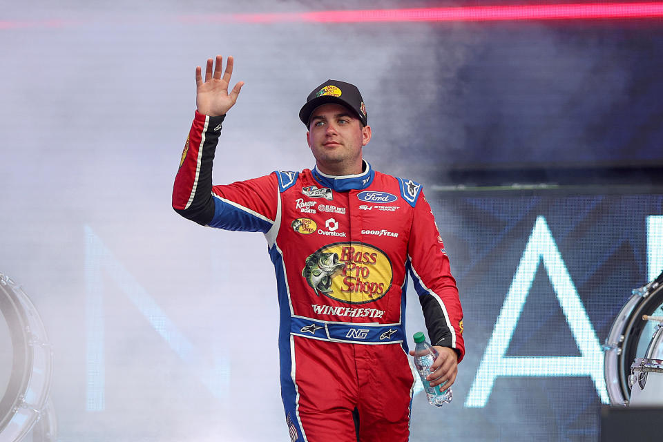 CHICAGO, ILLINOIS - JULY 06: Noah Gragson, driver of the #10 Bass Pro Shops Winchester Ford, waves to fans as he walks onstage during the NCS Driver Engagement on the Main Stage at the Chicago Street Course on July 06, 2024 in Chicago, Illinois. (Photo by Meg Oliphant/Getty Images)