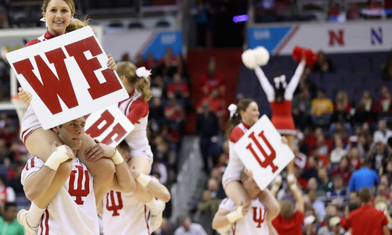 Indiana cheerleaders holding signs during a basketball game.