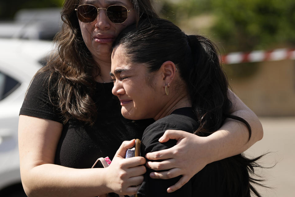 Mourners comfort each other at the funeral of Elan Ganeles, 27, a dual U.S.-Israeli citizen from West Hartford, Connecticut, in Raanana, Israel, Wednesday, March 1, 2023. The Israeli army said a suspected Palestinian gunman opened fire on Tuesday at an Israeli car near the Palestinian city of Jericho, hitting killing Ganeles. A friend told local media he had been visiting Israel for a wedding and driving on a highway near the Dead Sea when he was shot. (AP Photo/Tsafrir Abayov)