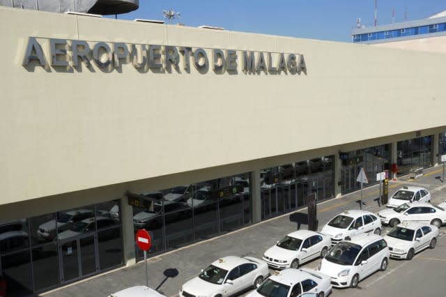 Exterior of airport of Malaga in Spain with taxicabs waiting outside.