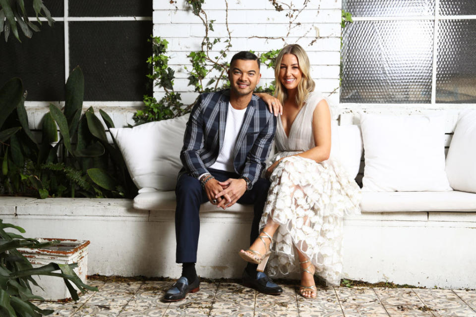 Guy Sebastian and Jules Sebastian, smiling on a couch