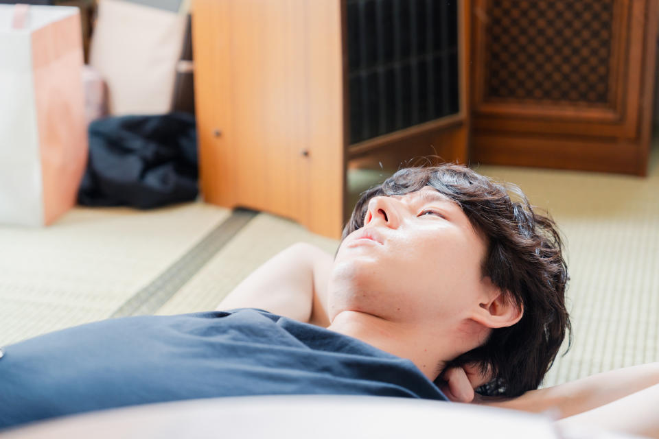 A young man laying on the floor